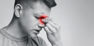 Moški se drži za nos