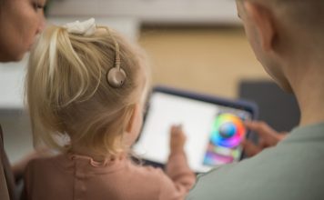 Otrok uporablja polžev vsadek za izboljšanje sluha